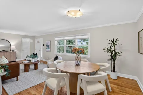 a dining room with furniture and wooden floor