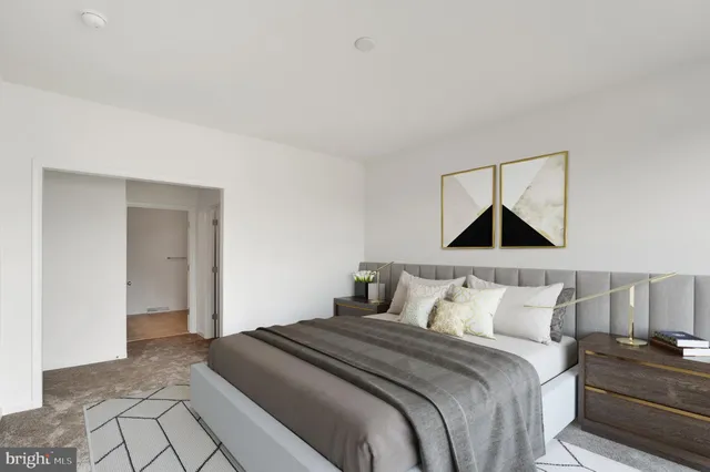 a bedroom with a bed and painting on the wall