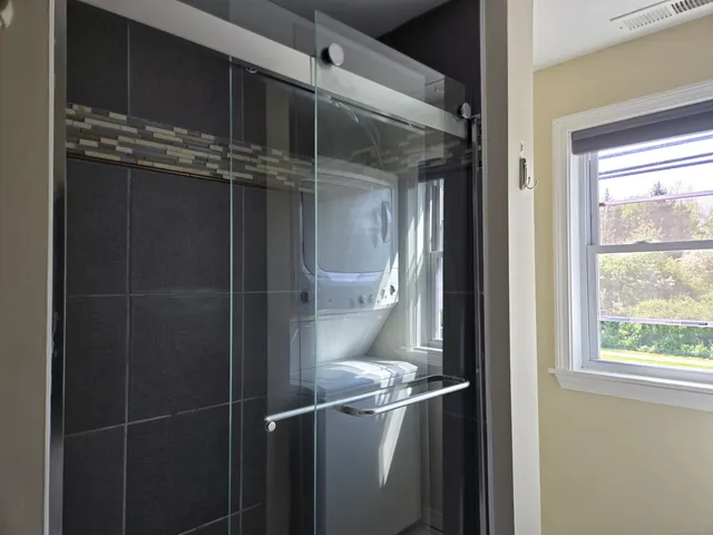 a bathroom with a glass shower door
