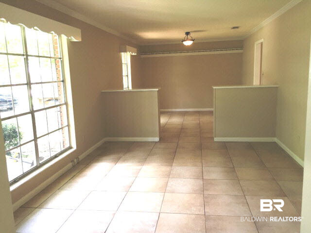 18832 Florida Street Robertsdale, AL 36567 - Photo 5 of 20 Formal living / dining rooms with crown molding, cornice boards over windows, ceramic tile on window sills. Tile flooring throughout.
