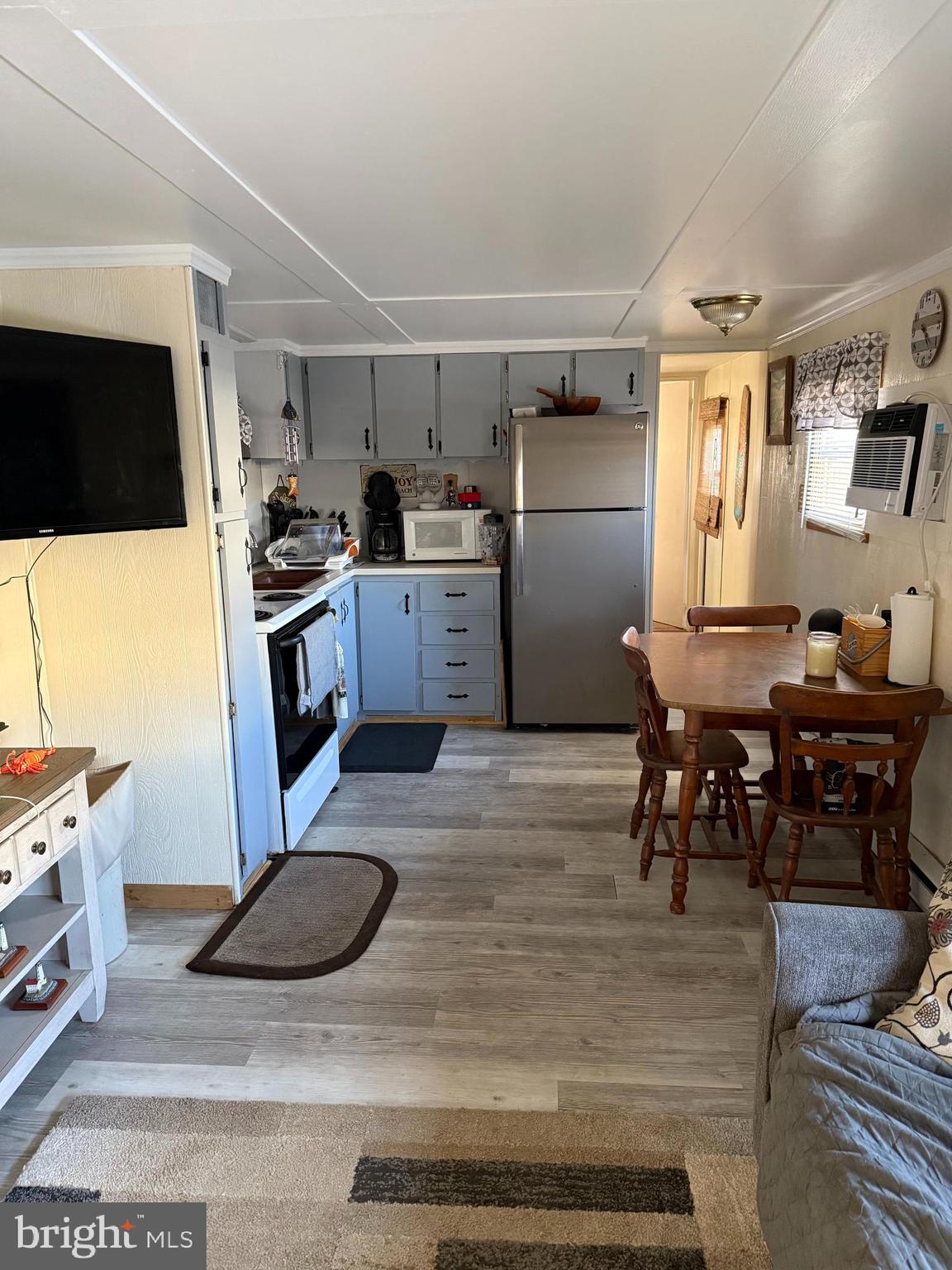 1 Adaline Avenue, Unit A Fortescue, NJ 08321 - Photo 5 of 11 a kitchen with refrigerator and chairs