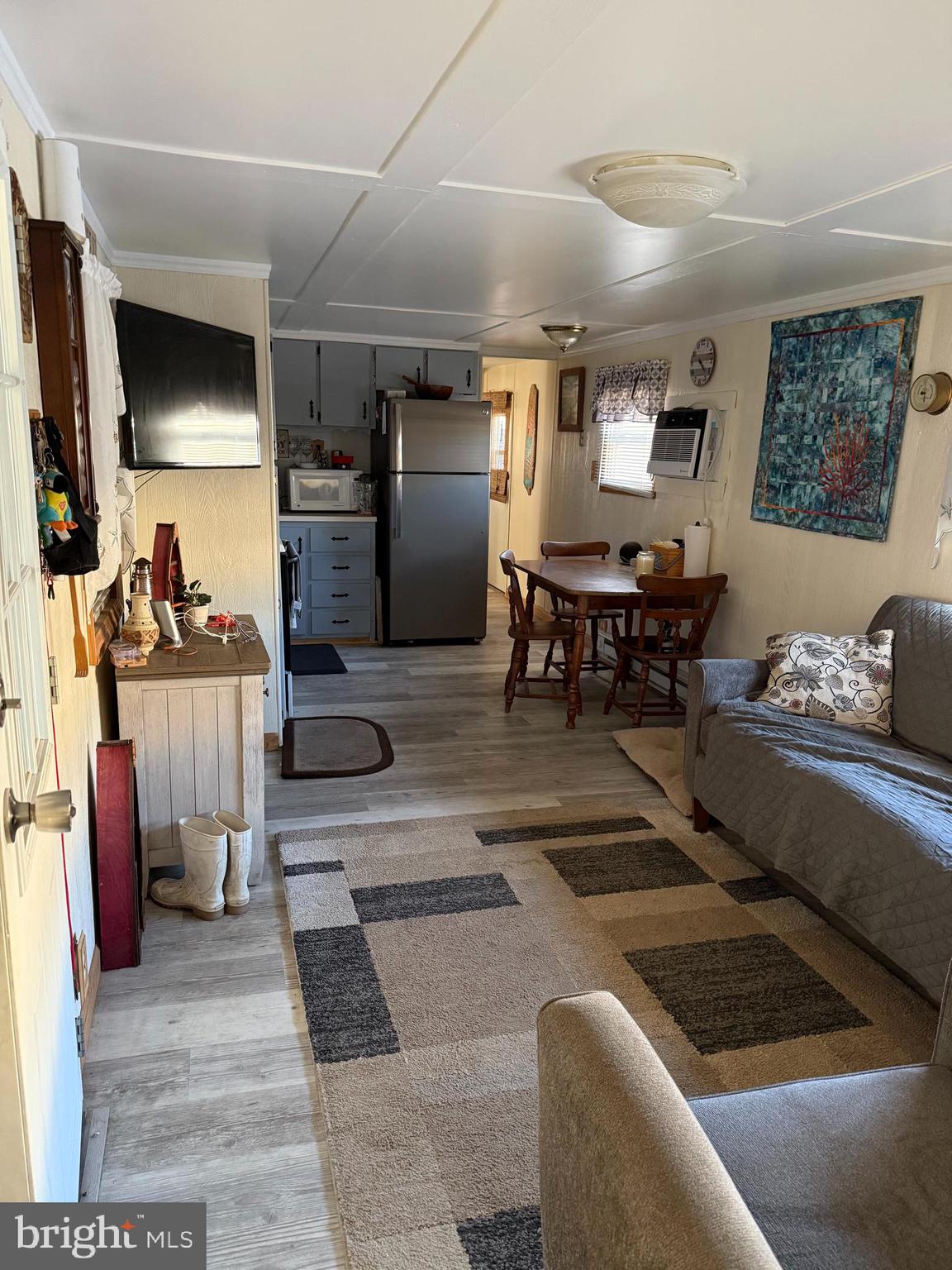 1 Adaline Avenue, Unit A Fortescue, NJ 08321 - Photo 8 of 11 a living room with furniture and a flat screen tv