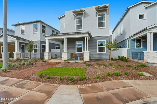 a front view of a house with garden and porch
