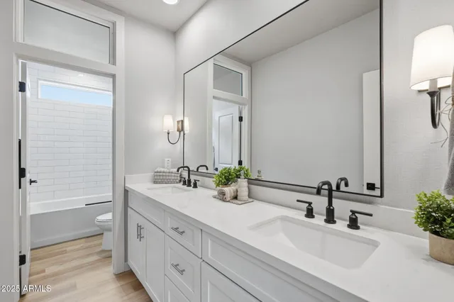 a bathroom with a double vanity sink mirror and double