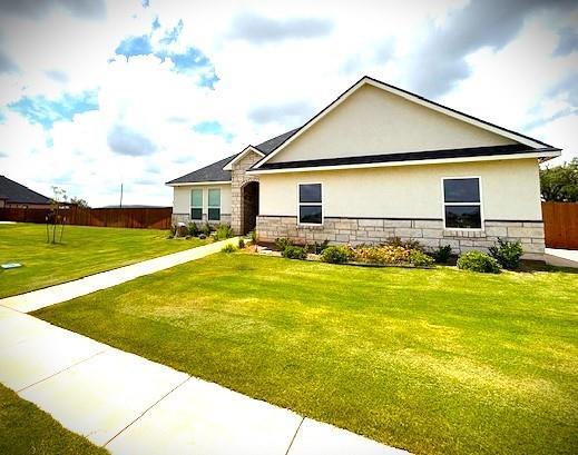 View of front of property featuring stucco siding and stone siding