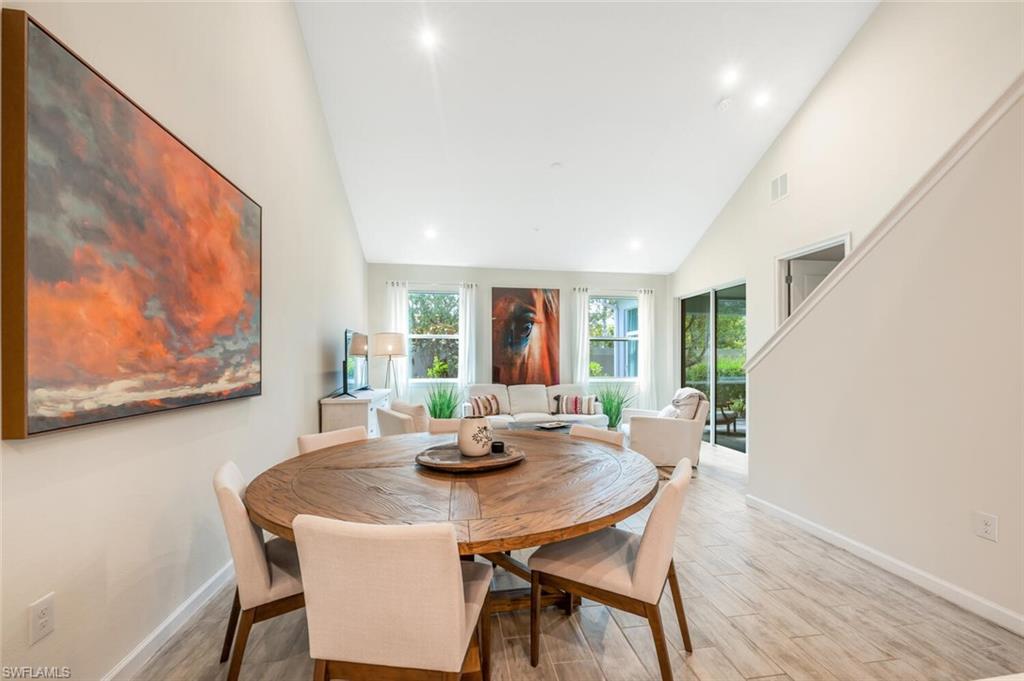 4720 Arboretum Circle, Unit 102 Naples, FL 34112 - Photo 10 of 44 a view of a dining room with furniture and wooden floor