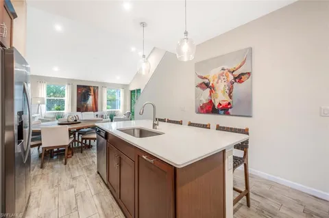 a kitchen with stainless steel appliances granite countertop a refrigerator stove and sink