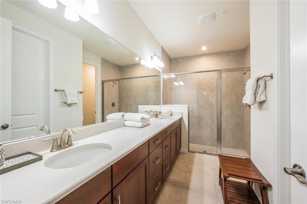 4720 Arboretum Circle, Unit 102 Naples, FL 34112 - Photo 18 of 44 a bathroom with a double vanity sink and mirror
