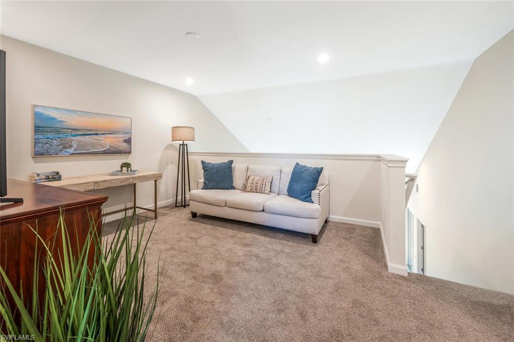 4720 Arboretum Circle, Unit 102 Naples, FL 34112 - Photo 21 of 44 a living room with furniture and a flat screen tv