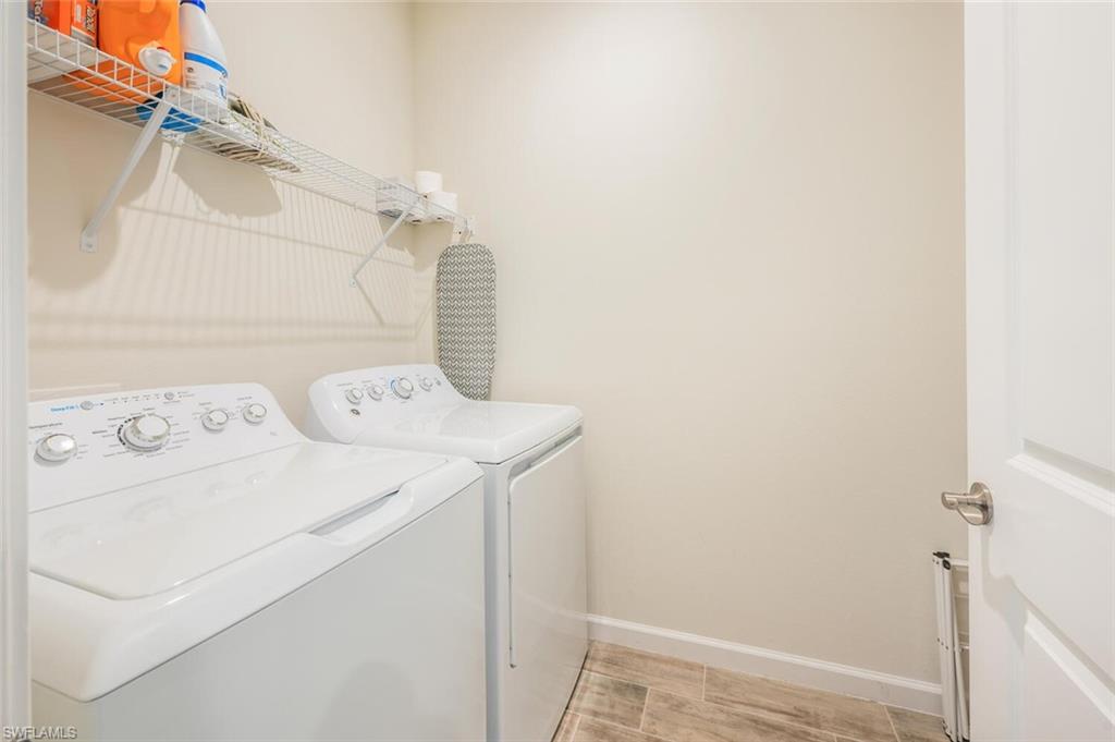 4720 Arboretum Circle, Unit 102 Naples, FL 34112 - Photo 26 of 44 a utility room with dryer and washer