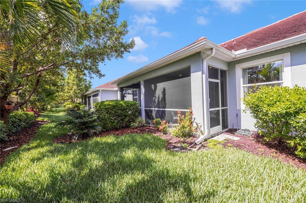 4720 Arboretum Circle, Unit 102 Naples, FL 34112 - Photo 31 of 44 a front view of a house with garden