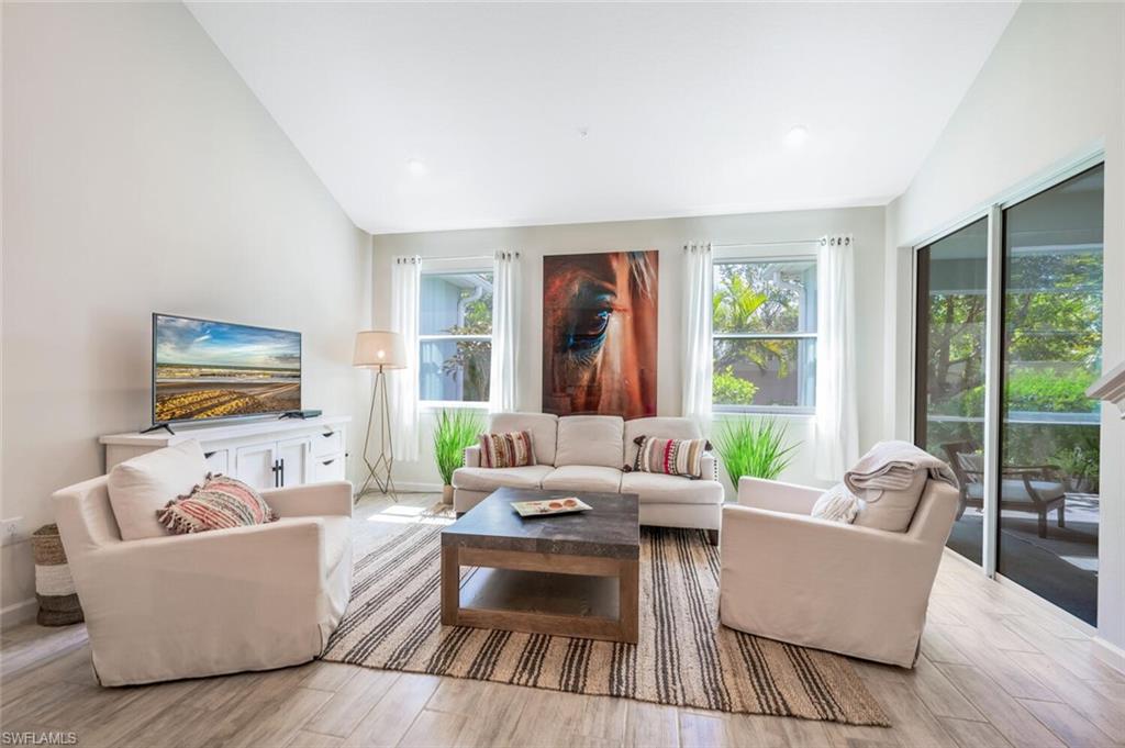 4720 Arboretum Circle, Unit 102 Naples, FL 34112 - Photo 6 of 44 a living room with furniture and a large window