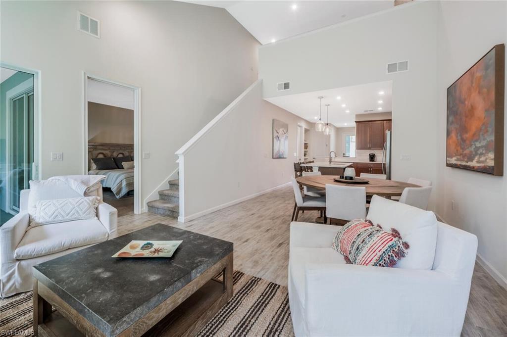 4720 Arboretum Circle, Unit 102 Naples, FL 34112 - Photo 8 of 44 a living room with furniture and kitchen view