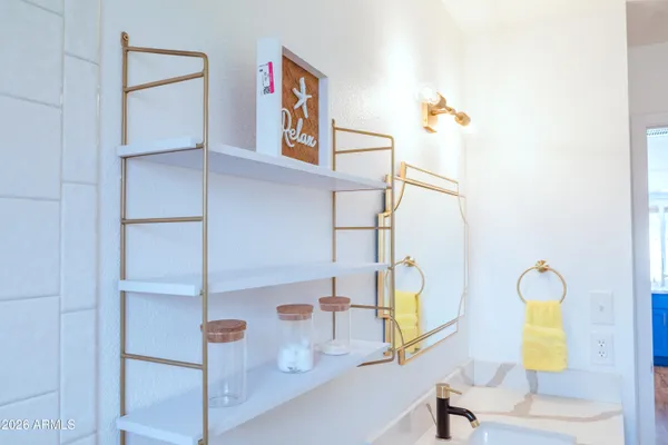 a en suite bathroom with a double vanity sink and a mirror