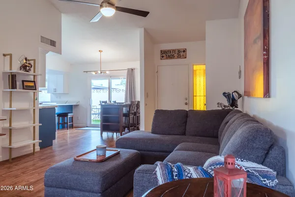 a living room with furniture fireplace and a large window