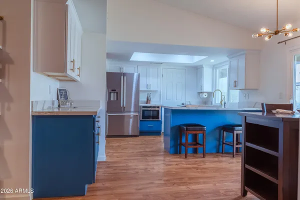 a kitchen with granite countertop wooden cabinets a sink and a window