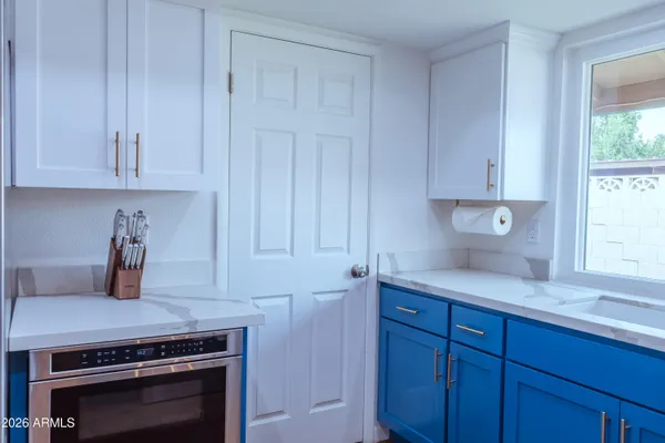 a kitchen with a refrigerator and a table