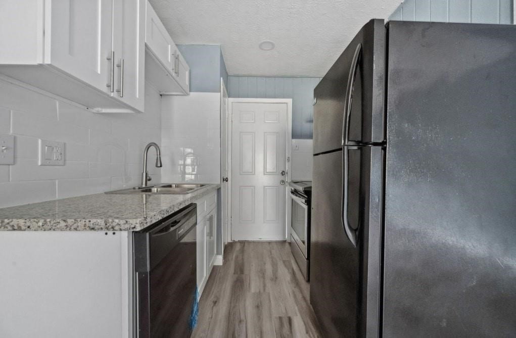 3423 Nettleton Street Houston, TX 77004 - Photo 7 of 14 a kitchen with stainless steel appliances granite countertop a refrigerator and a sink