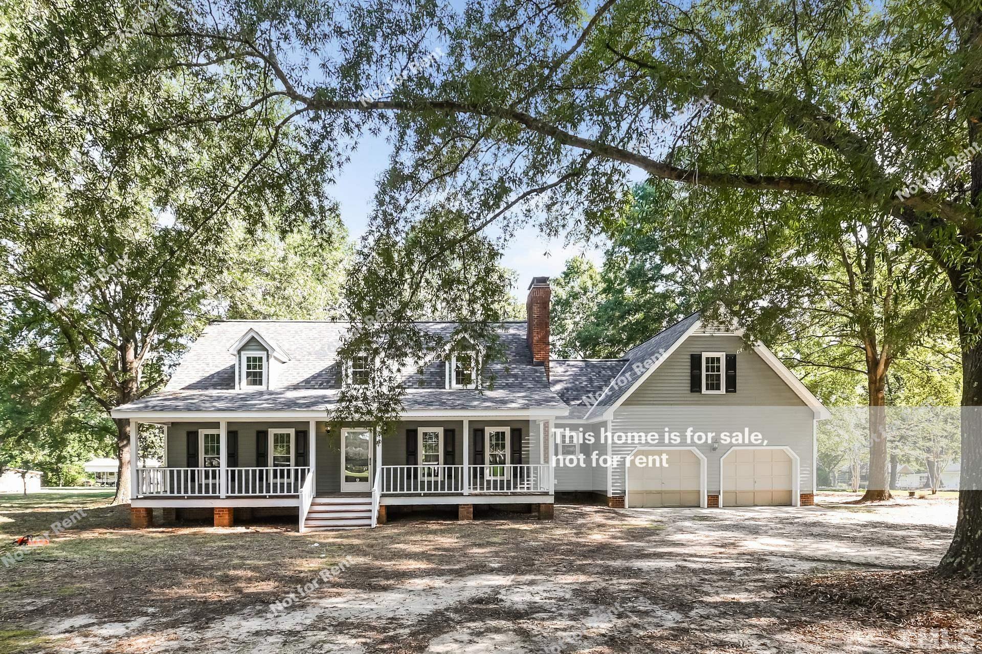 6587 Dwight Rowland Road Willow Spring, NC 27592 - Photo 1 of 25 a front view of a house with a garden