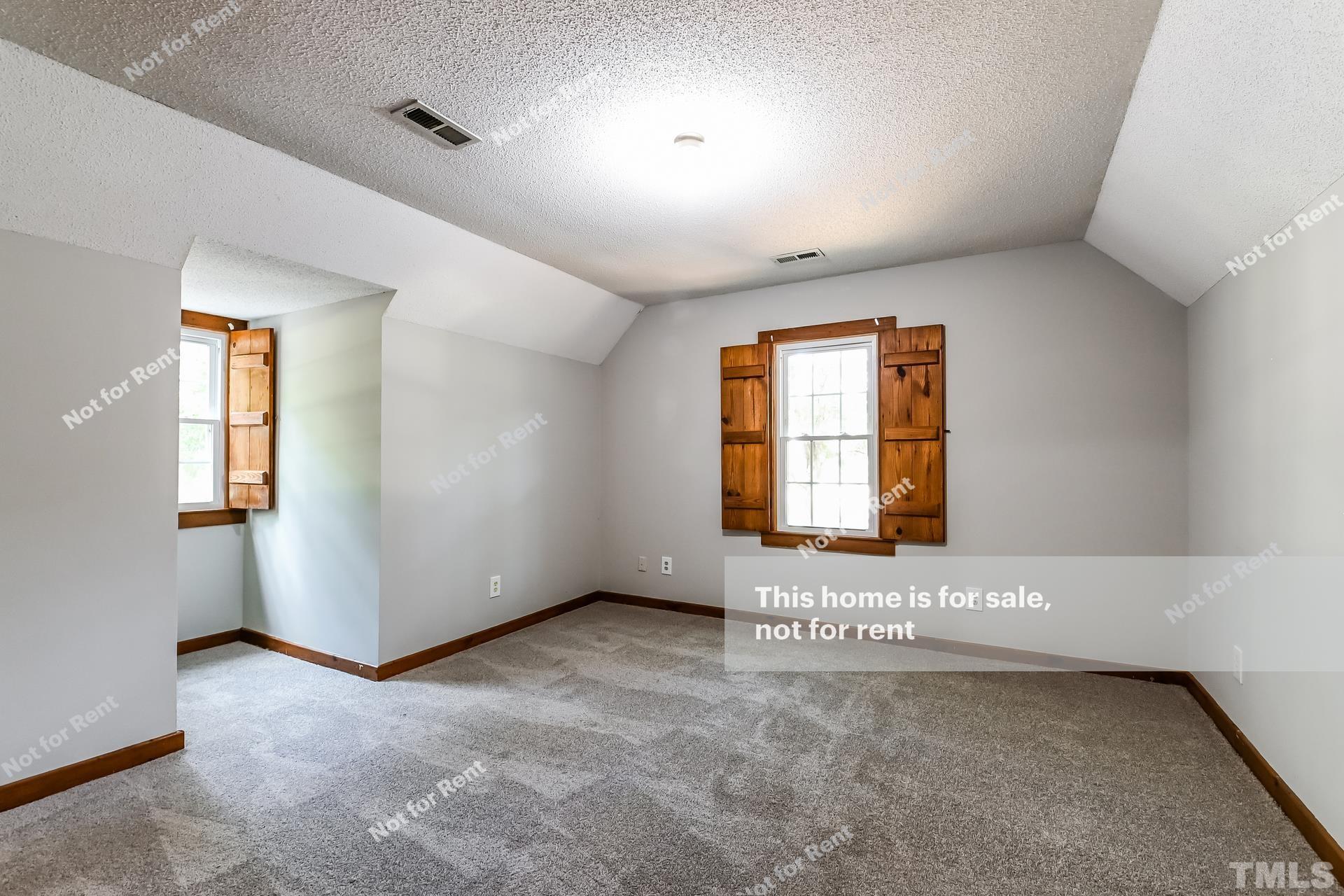 6587 Dwight Rowland Road Willow Spring, NC 27592 - Photo 15 of 25 a view of an empty room with a window