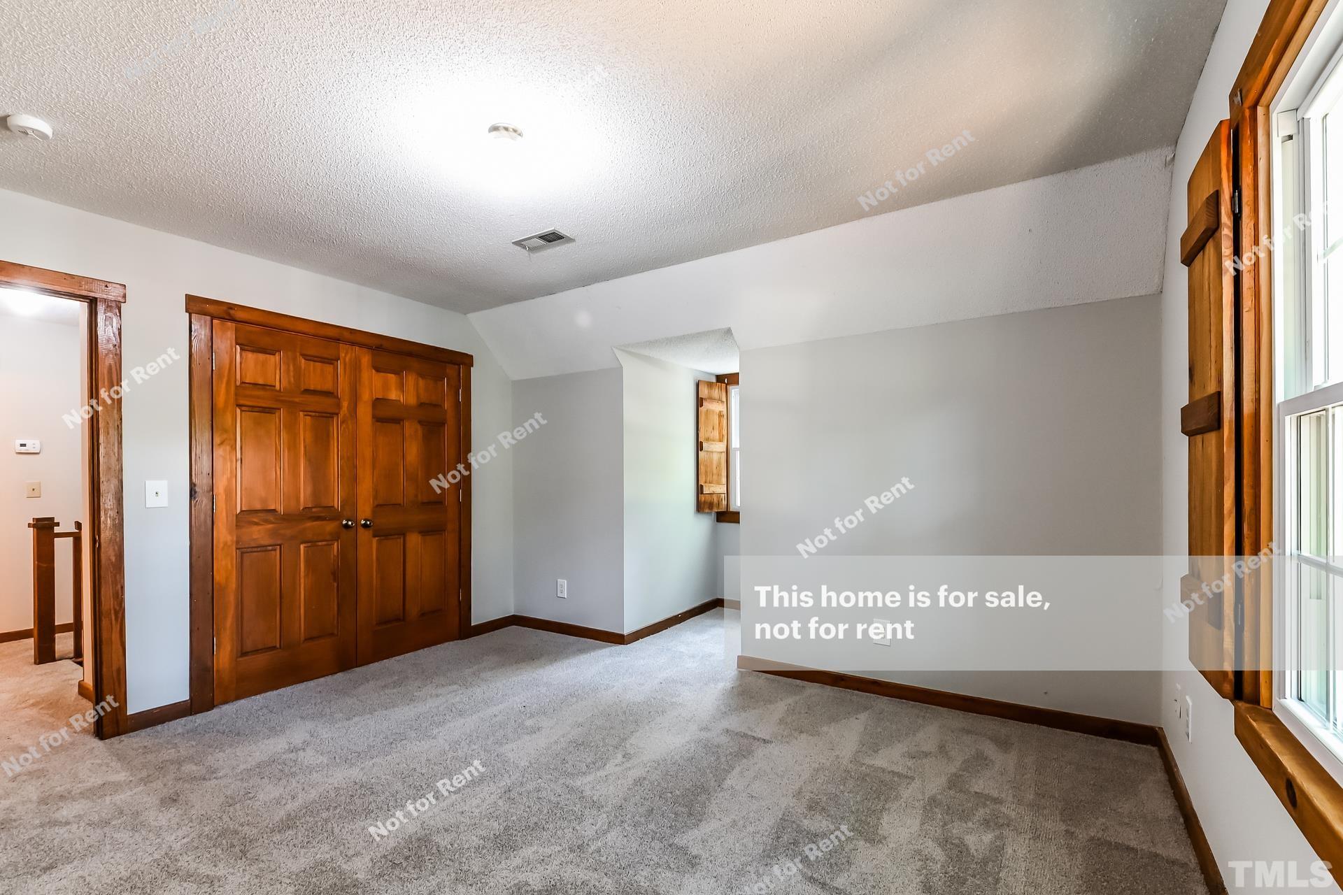 6587 Dwight Rowland Road Willow Spring, NC 27592 - Photo 16 of 25 a view of a big room with closet and windows