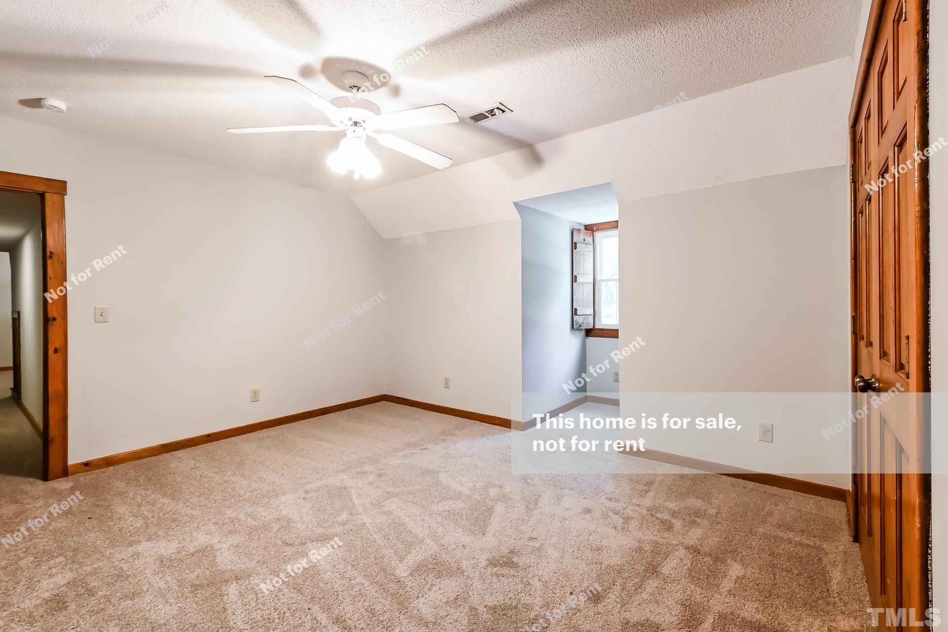 6587 Dwight Rowland Road Willow Spring, NC 27592 - Photo 17 of 25 a view of a big room with chandelier fan and windows