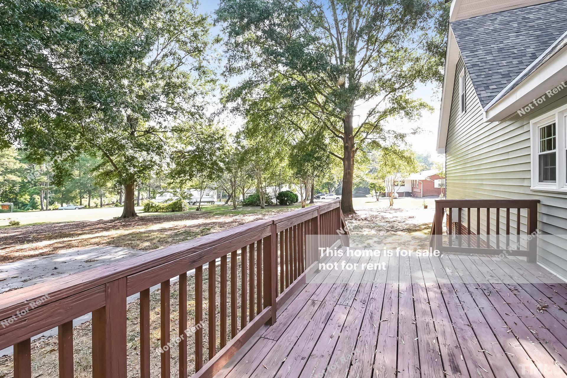 6587 Dwight Rowland Road Willow Spring, NC 27592 - Photo 24 of 25 a view of balcony with wooden floor and fence