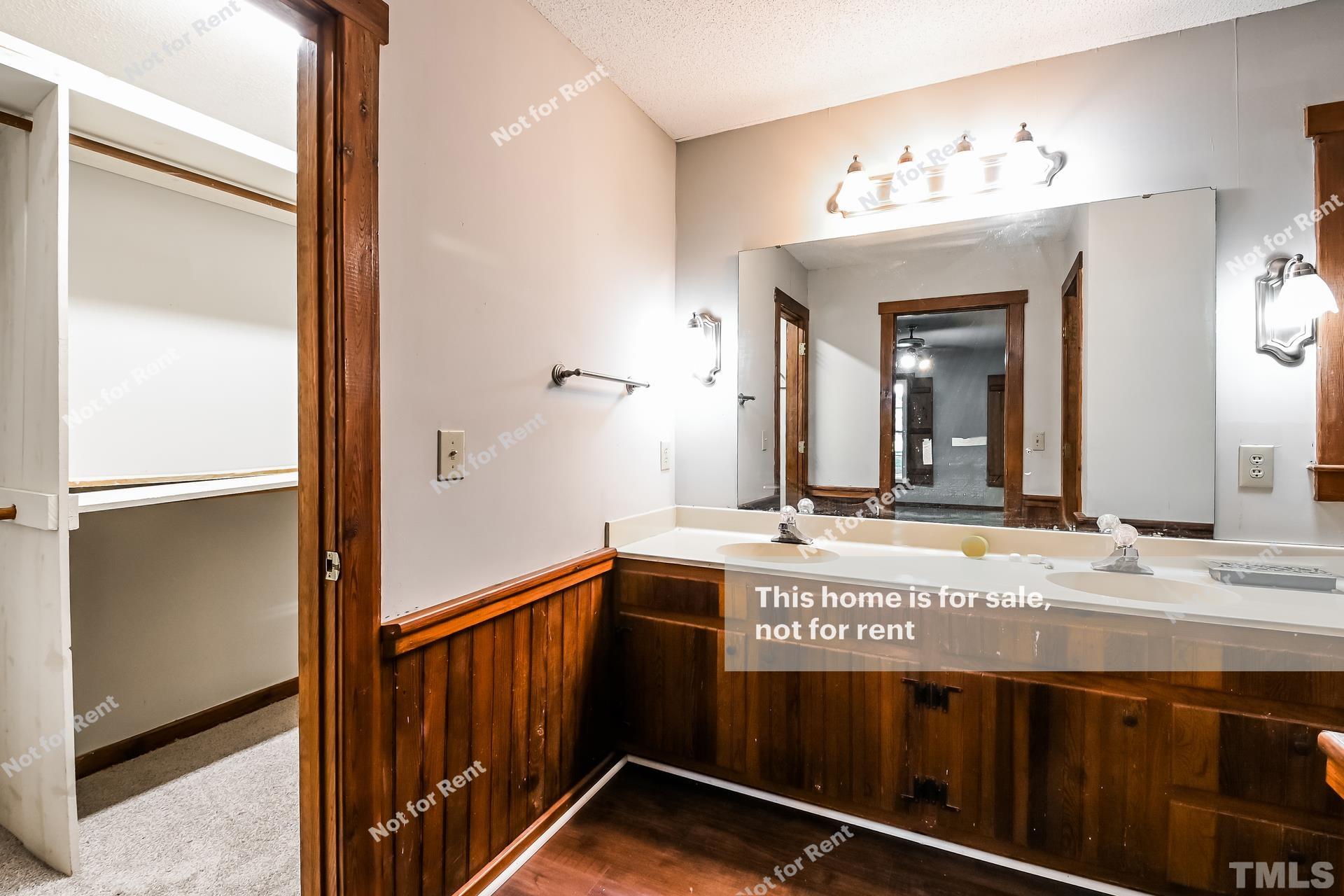 6587 Dwight Rowland Road Willow Spring, NC 27592 - Photo 6 of 25 a bathroom with a sink and a mirror