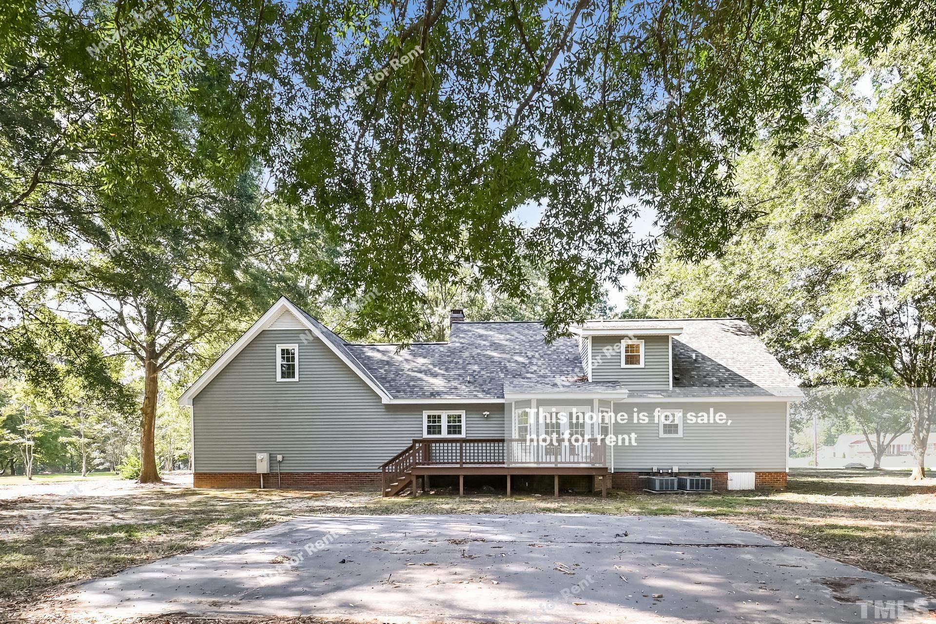 6587 Dwight Rowland Road Willow Spring, NC 27592 - Photo 7 of 25 a house with a tree in front of it
