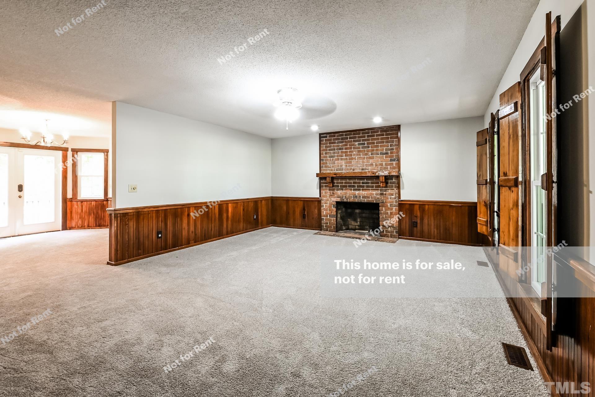 6587 Dwight Rowland Road Willow Spring, NC 27592 - Photo 8 of 25 a large hall with a fireplace
