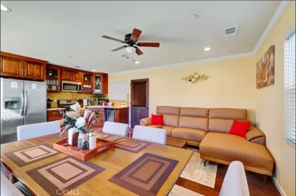 a living room with furniture and a view of kitchen