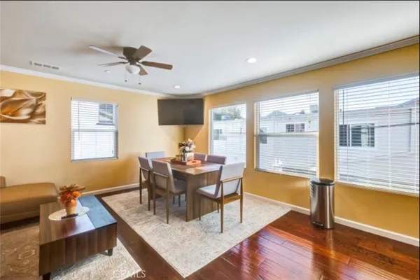 a view of a dining room with furniture window and wooden floor