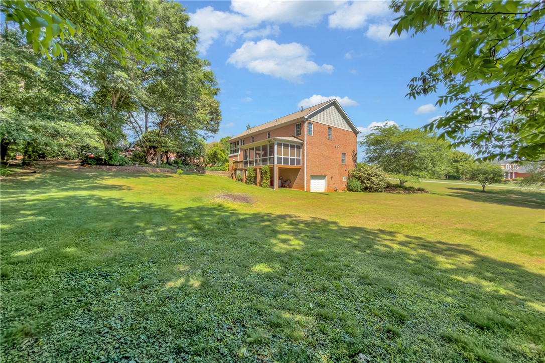 406 Hopewell Ridge Anderson, SC 29621 - Photo 44 of 46 This spacious property features a charming brick home with a large yard, ideal for outdoor living.