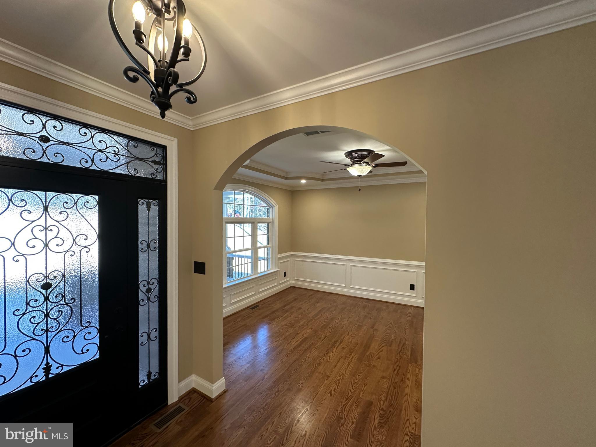 1 Keval Gyan Way Winchester, VA 22603 - Photo 19 of 48 a room with wooden floor chandelier fan and windows