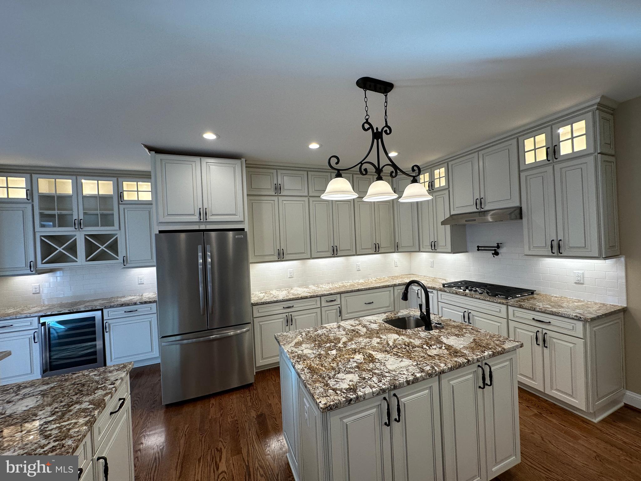 1 Keval Gyan Way Winchester, VA 22603 - Photo 24 of 48 a kitchen with kitchen island a sink appliances and cabinets