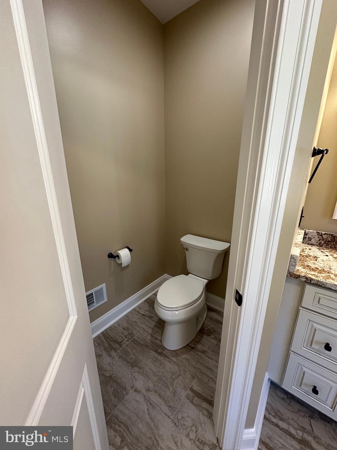 1 Keval Gyan Way Winchester, VA 22603 - Photo 33 of 48 a bathroom with a granite countertop toilet and a sink