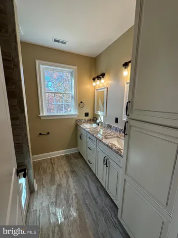 a view with cabinets and wooden floor