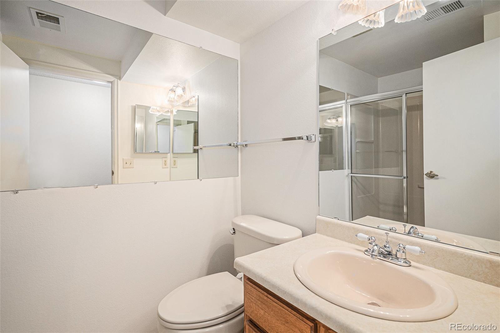 16 Shetland Court Highlands Ranch, CO 80130 - Photo 19 of 25 a bathroom with a sink a toilet and shower