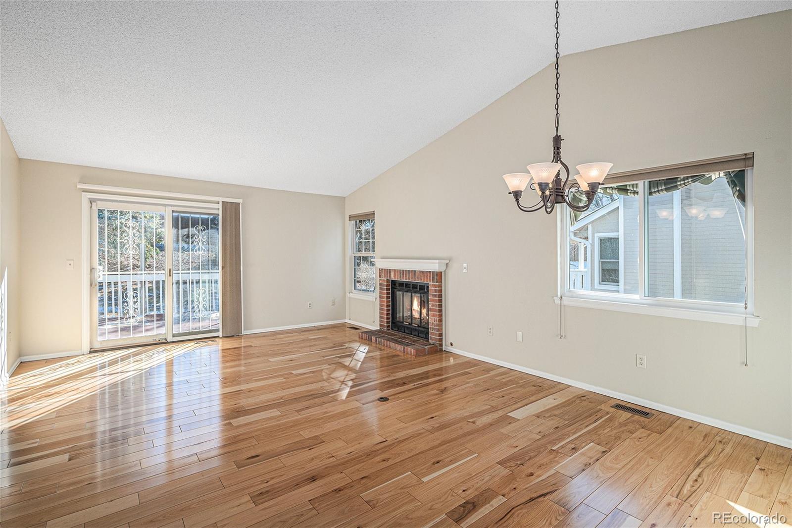 16 Shetland Court Highlands Ranch, CO 80130 - Photo 2 of 25 a view of an empty room with wooden floor and a window