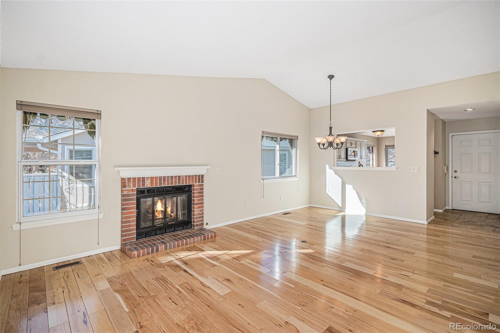 16 Shetland Court Highlands Ranch, CO 80130 - Photo 3 of 25 a view of empty room with wooden floor and fireplace
