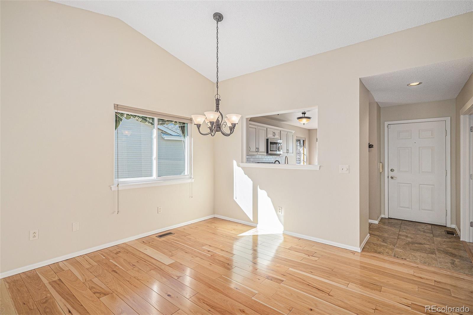 16 Shetland Court Highlands Ranch, CO 80130 - Photo 4 of 25 a view of empty room with wooden floor and fan