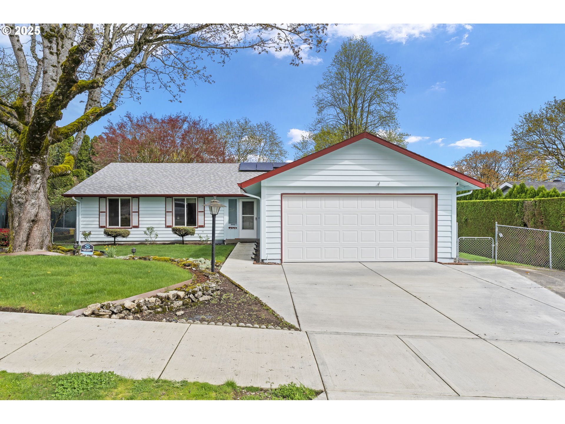 a front view of a house with a garden and yard