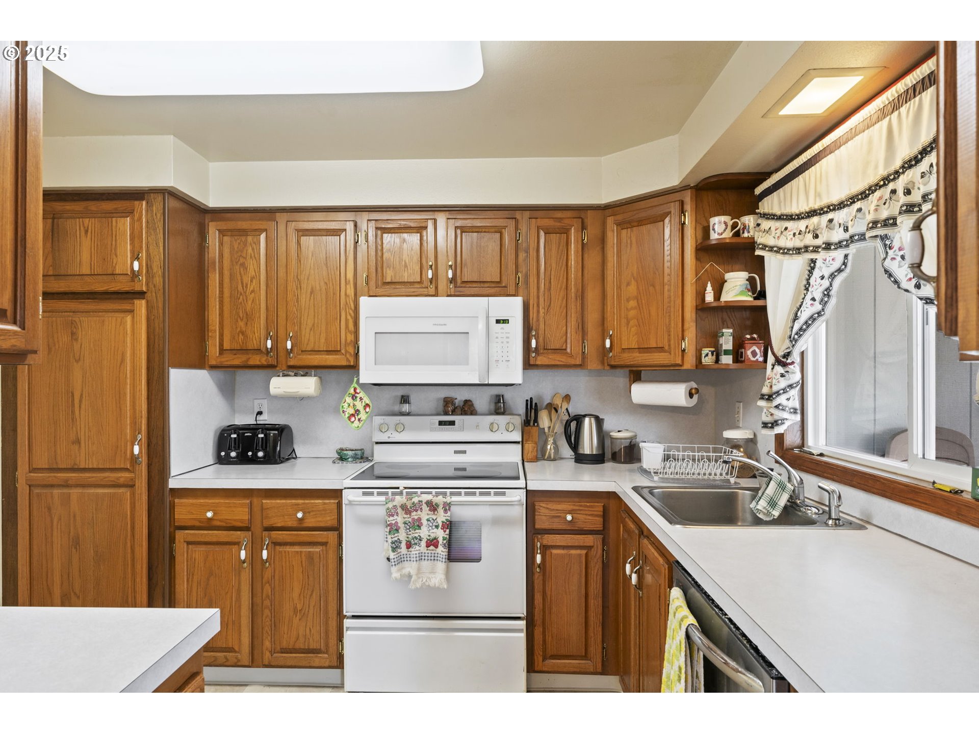 2320 Northeast Juniper Avenue Gresham, OR 97030 - Photo 14 of 34 a kitchen with a sink a stove and cabinets