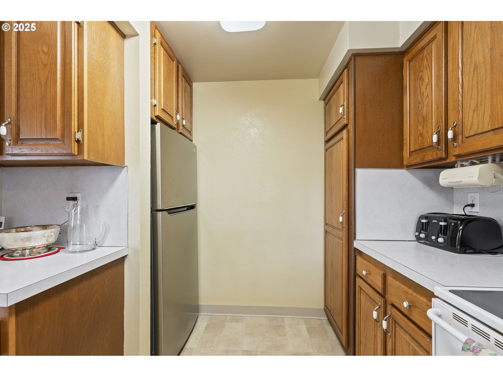 2320 Northeast Juniper Avenue Gresham, OR 97030 - Photo 15 of 34 a kitchen with stainless steel appliances white cabinets and a refrigerator