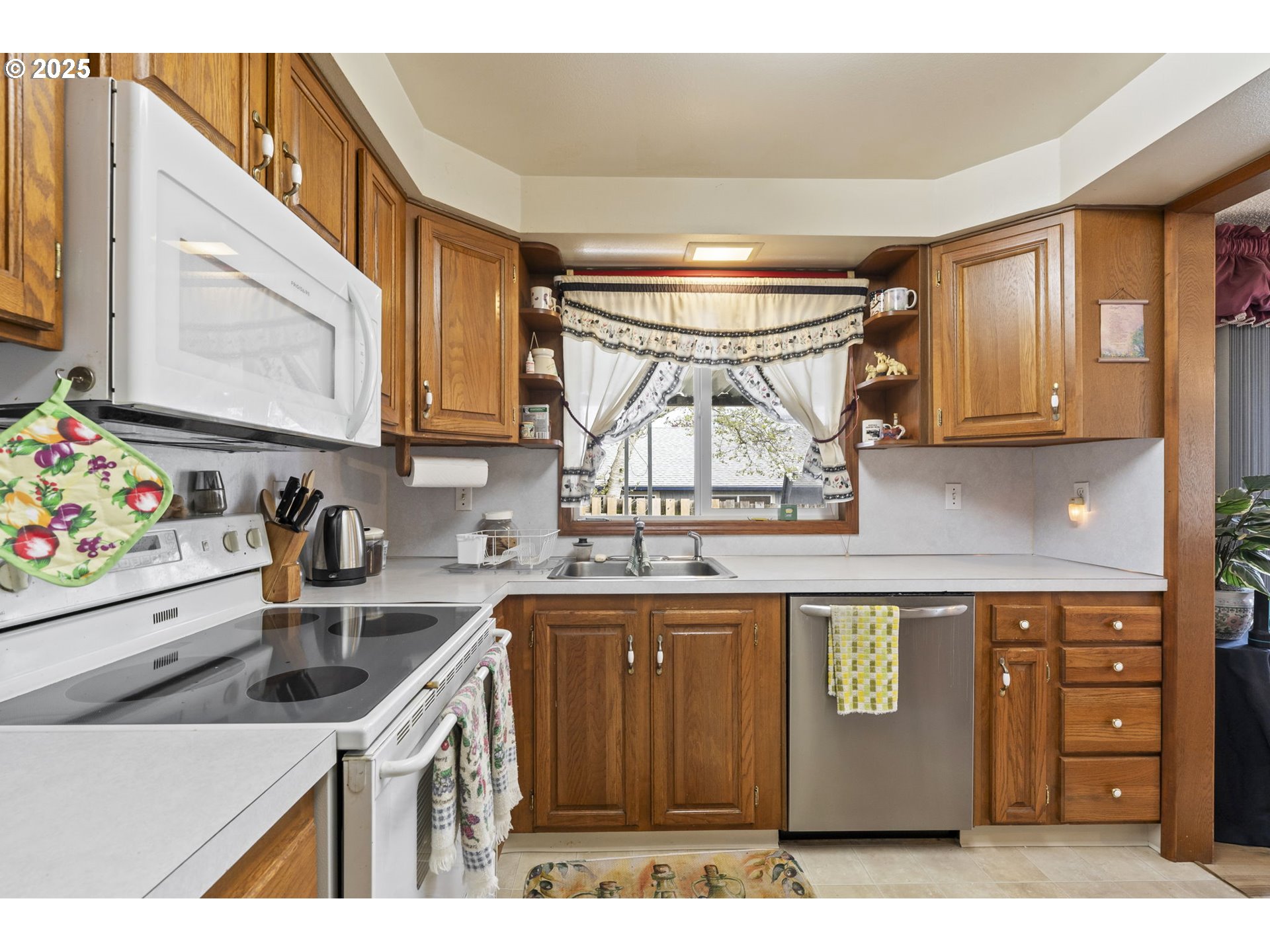2320 Northeast Juniper Avenue Gresham, OR 97030 - Photo 16 of 34 a kitchen with a sink a stove and cabinets