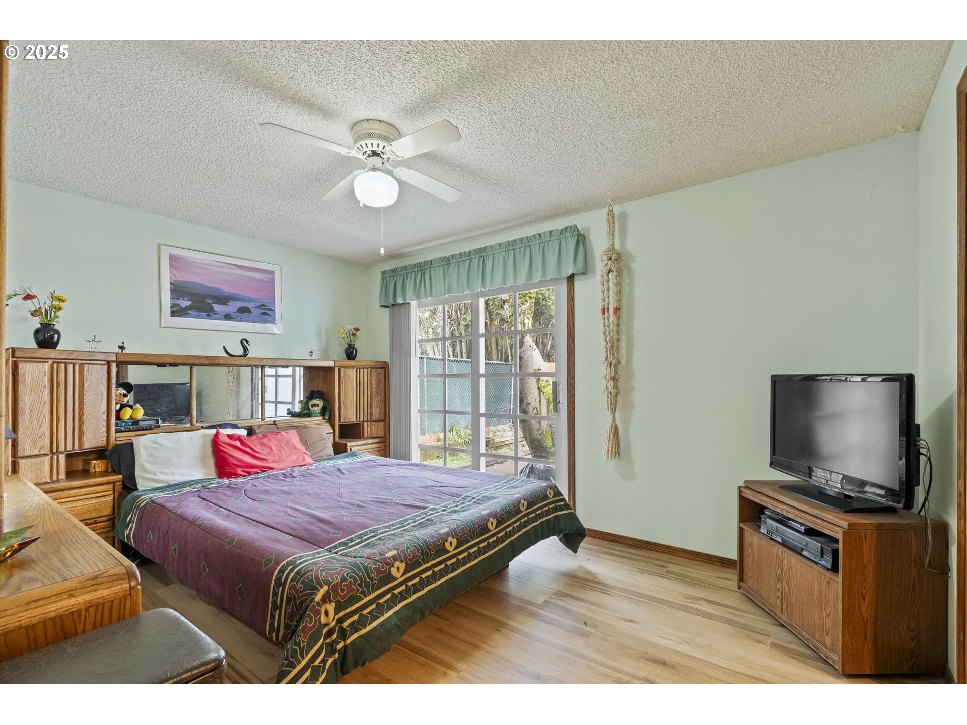 2320 Northeast Juniper Avenue Gresham, OR 97030 - Photo 17 of 34 a bedroom with a bed and a flat screen tv