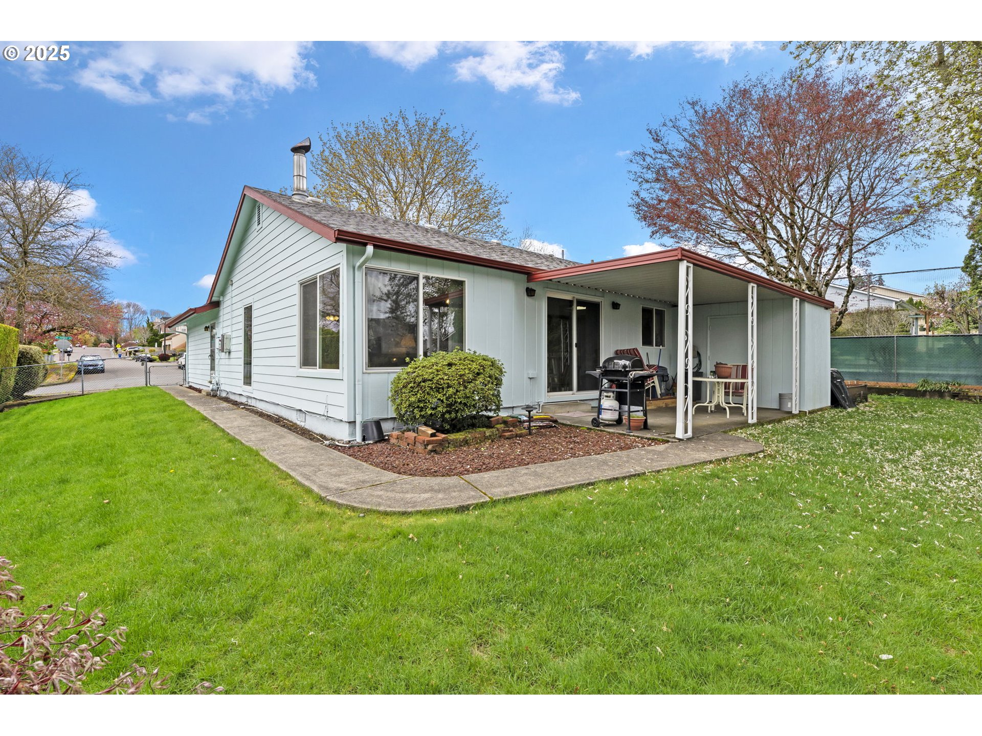 2320 Northeast Juniper Avenue Gresham, OR 97030 - Photo 28 of 34 a view of a patio with table and chairs potted plants and large tree