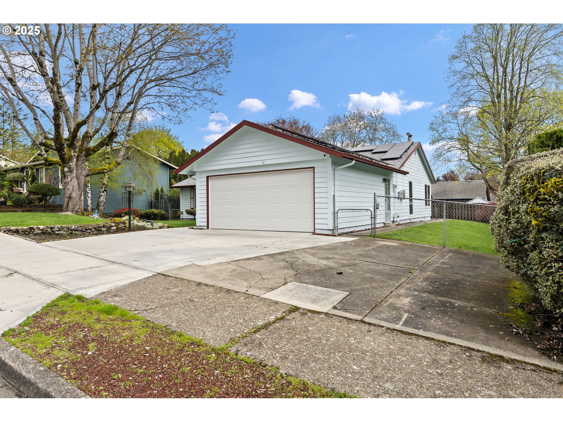 2320 Northeast Juniper Avenue Gresham, OR 97030 - Photo 3 of 34 a front view of a house with a yard and garage