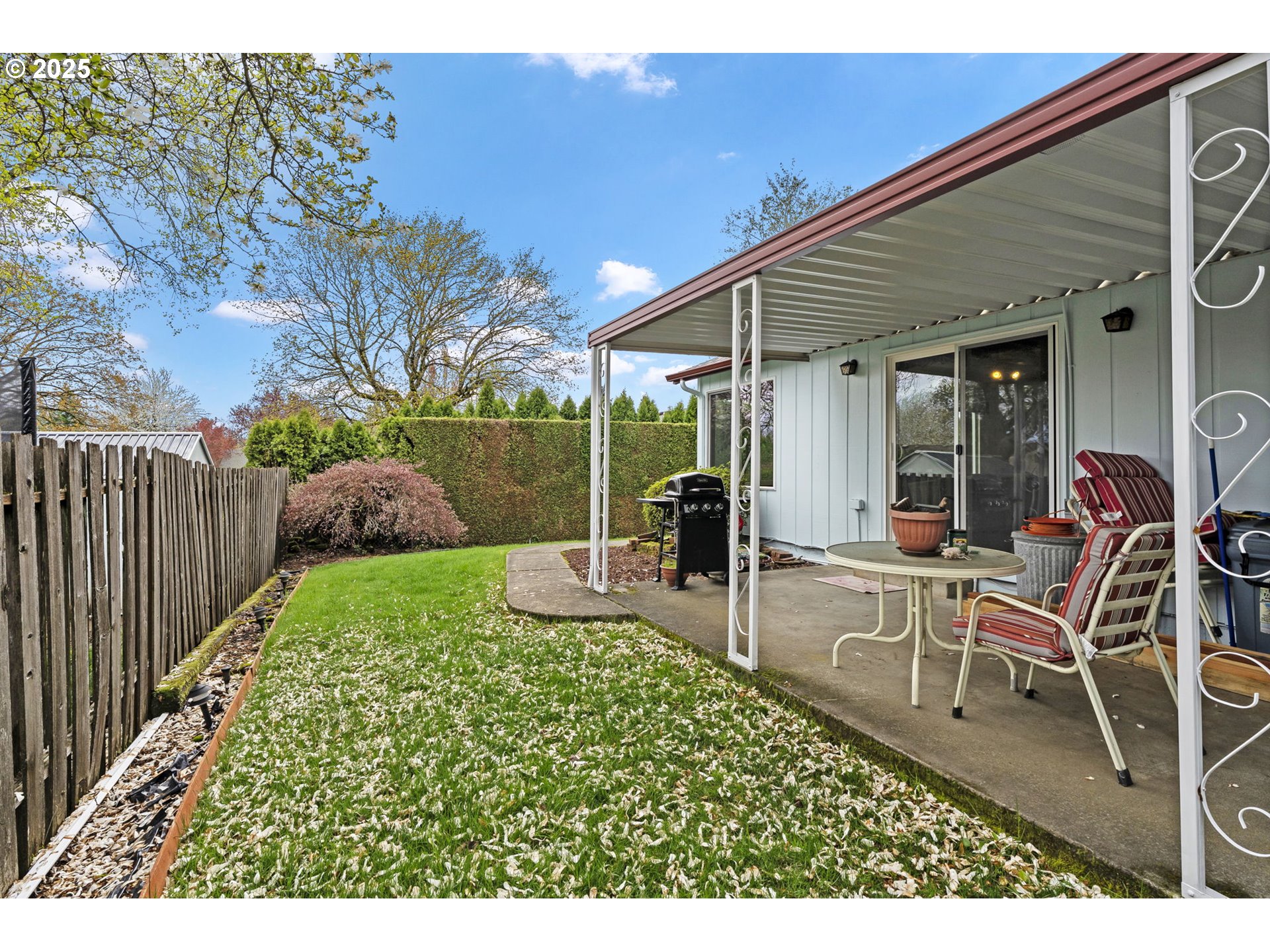 2320 Northeast Juniper Avenue Gresham, OR 97030 - Photo 31 of 34 a view of a patio with table and chairs and wooden fence