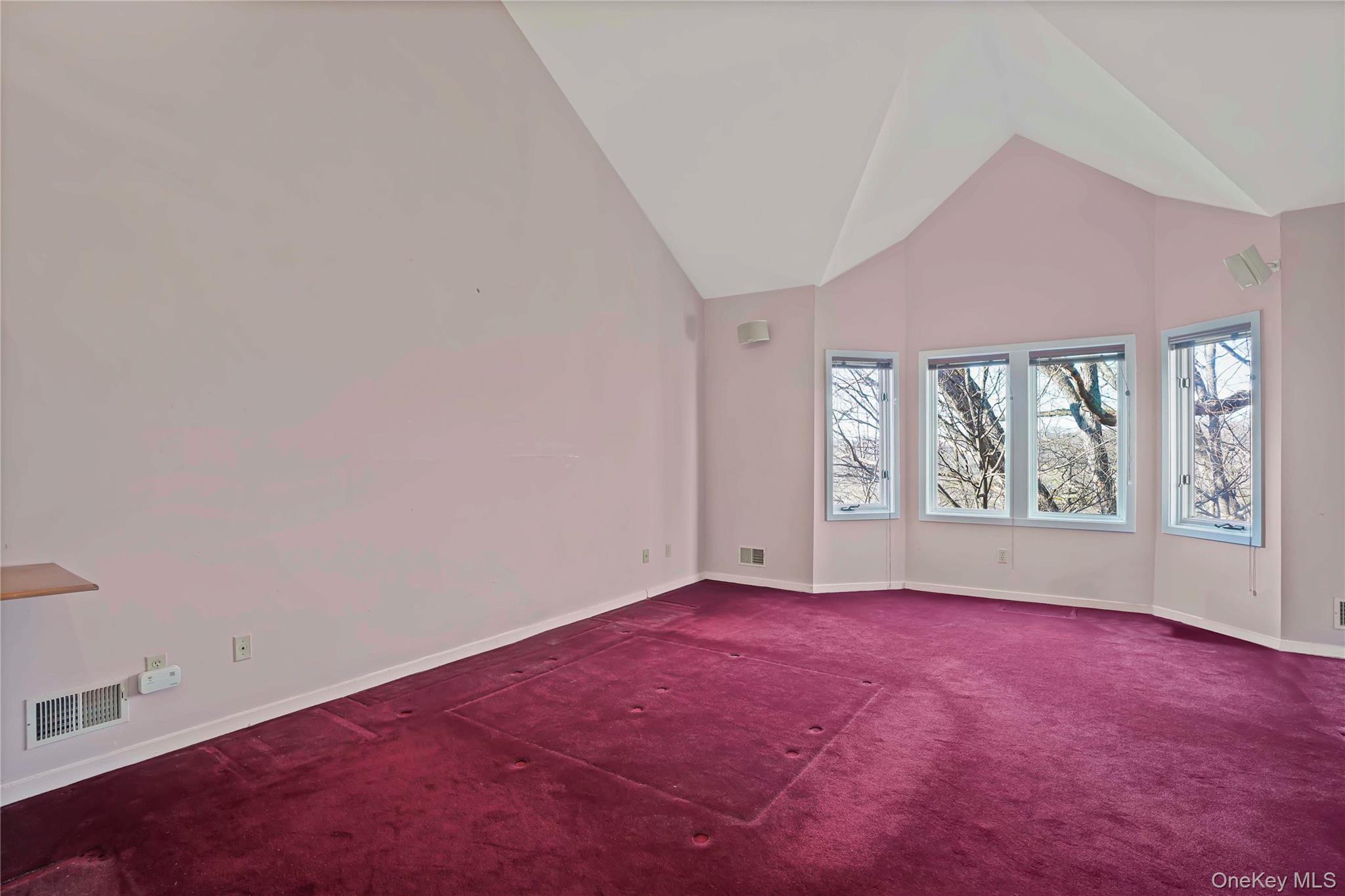 208 Boulder Ridge Road Scarsdale, NY 10583 - Photo 16 of 43 Spare room with high vaulted ceiling and carpet